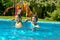 Kids in swimming pool have fun in water, children on family vacation