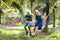 Kids on swing. Playground in tropical resort