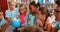 Kids and teacher looking at globe in library