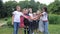 Kids team building. A group of happy children holding hands together. Team outdoor in park