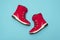 Kids or teenage pink winter boots isolated on blue background. Winter boots for girls