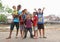 Kids and teens posing on bank of river in Manado