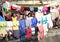 Kids and teens posing among laundry in Manado