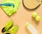 Kids tennis stuff on cream background. Sport, fitness, tennis, healthy lifestyle, sport stuff. Tennis racket, lime trainers, tenni