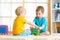 Kids toddler preschooler boys playing logical toy learning shapes and colors at home or nursery