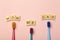 Kids toothbrushes of different colors on a pink background. Teeth and oral hygiene for children