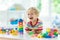 Kids toys. Child building tower of toy blocks