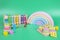 Kids toys collection. Wooden rainbow, educational and music baby toys on light green background