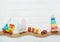 Kids toys on toy wooden railway on white wooden background