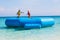 Kids on trampoline on tropical sea beach