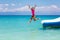 Kids on trampoline on tropical sea beach