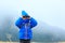 Kids travel - little boy with binoculars hiking in mountains