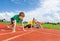 Kids in uniforms on bended knee ready to run