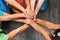 Kids unite. High angle shot of a group of unrecognizable kids joining their hands in solidarity.