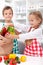 Kids unpacking vegetables in the kitchen