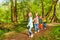 Kids walking in the summer forest holding hands