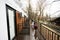 Kids walking on terrace of one-storey modular houses in spring rainy forest