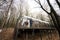 Kids walking on terrace of one-storey modular houses in spring rainy forest