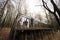 Kids walking on terrace of one-storey modular houses in spring rainy forest