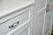 Kids wardrobe and chest of drawers. Classic children`s furniture in white color close-up