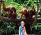 Kids watch monkeys in zoo. Child and animals.