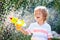 Kids with water gun toy in garden. Outdoor fun