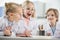 Kids wearing protective glasses in science laboratory