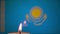 Kiev, Ukraine, January 2022: - Memorial single burning candle in front of background of blurred Kazakh flag. Selective