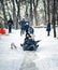 Kiev, Ukraine - January 26, 2014: teenagers people sledging through snowy woodland on rubber tires