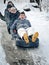 Kiev, Ukraine - January 26, 2014: teenagers people sledging through snowy woodland on rubber tires