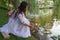 Kiev, Ukraine - July 06, 2018: Girl launches a wreath performing a Slavic ritual of fortune telling on the pagan holiday of Ivan K