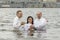 Kiev, Ukraine. July 22 2018 Two pastors baptize girl. People take water baptism in the river