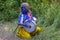 Kiev, Ukraine - July 24, 2018: Boy disguised as a young Krishna is playing a drum at the festival