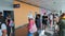 KIEV, UKRAINE - JULY 31, 2021: people in line to airport toilet, masked passengers arriving from vacation are talking on