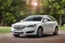 Kiev, Ukraine - June 19, 2018: White Opel Insignia on the road in a beautiful forest