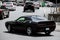 Kiev, Ukraine - June 19, 2021: Black muscle car Dodge Challenger on the road