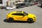 Kiev, Ukraine - May 22, 2021: Yellow luxury super SUV Lamborghini Urus in motion. Lamborghini Urus SSUV in the city