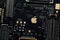 Kiev, Ukraine - May 6, 2020: Image of a golden apple on the iphone se phone motherboard. Detached loopback connectors. Close-up,