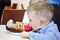 Kiev, Ukraine - November 11, 2017: A little boy in a shirt eating a sweet cake