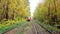 KIEV, UKRAINE - OCTOBER 21, 2018: The red vintage city tram drives amid the yellow trees of autumn forest of Pushcha-Voditsa spa r