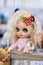 KIEV, Ukraine - September 06 ,2020: The doll looks like a real one. White-haired doll with big eyes and pink dress