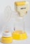 KIEV, UKRAINE - September 25, 2019: automatic yellow breast pump with a pacifier