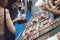 Kiev, Ukraine â€“ 19 September, 2018: Young woman chooses decorative cosmetics at the beauty store stand during beauty show. Girl