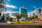 Kigali, Rwanda - September 21, 2018: A car passes the city centre roudabout, with Pension Plaza and surrounding buildings in
