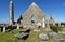 Kilmacduagh monastery with stone tower in Ireland.