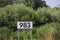 Kilometer distance sign at the river Lek in the Netherlands, counting from the origin of Rhine river in Switserland