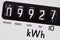 Kilowatt electric meter dial macro close-up.