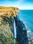 Kilt Rock Waterfall in winter midday. Kilt rock coastline cliff and waterfall in Scottish highlands