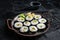 Kimbap gimbap filled with vegetables, egg, eanchovy and crab, Korean rice roll. Black background. Top view