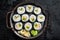 Kimbap gimbap filled with vegetables, egg, eanchovy and crab, Korean rice roll. Black background. Top view